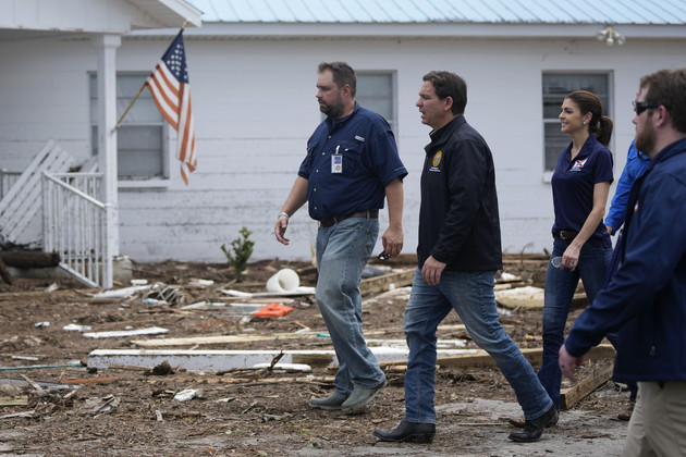 Florida Gov. Ron DeSantis, center right, and his wife Casey, second right, visit the storm-damaged First Baptist Church.