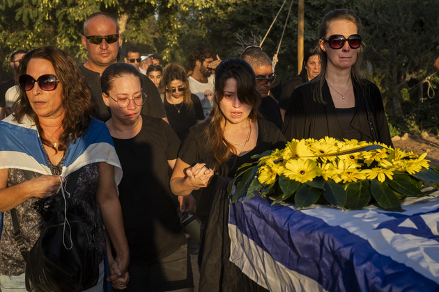 Relatives attend the funeral of Albert Miles, 81, at the Kibbutz Revivim cemetery.