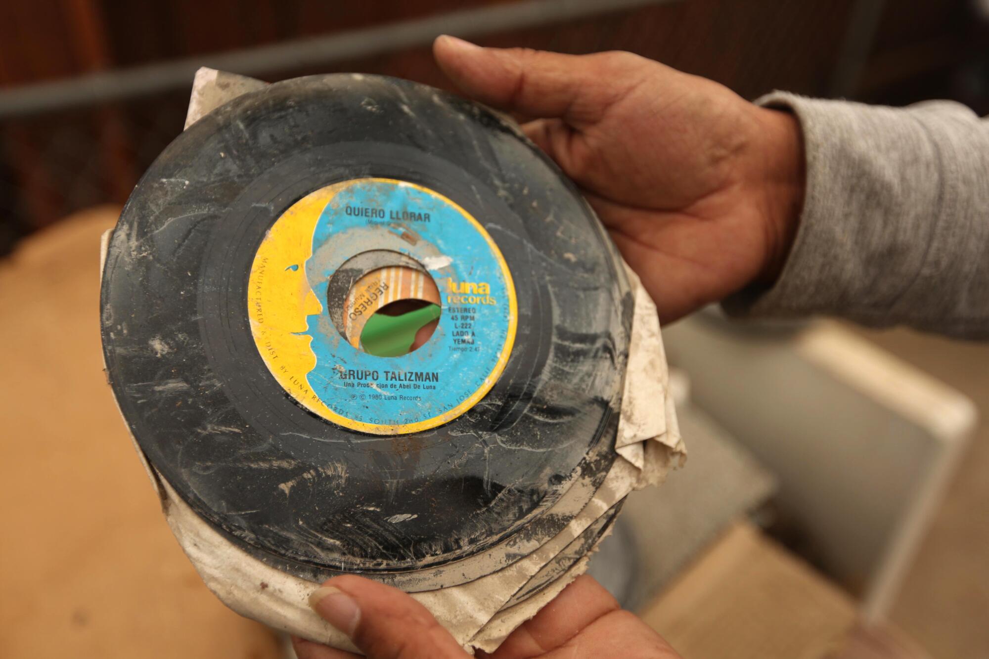 A close-up of water-damaged vinyl records. 