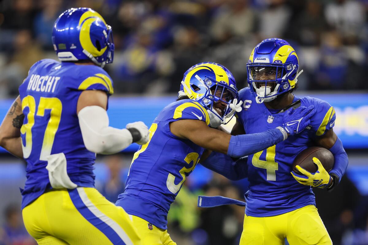 Rams safety Jordan Fuller (4) is congratulated by teammates after his interception against the Saints.  