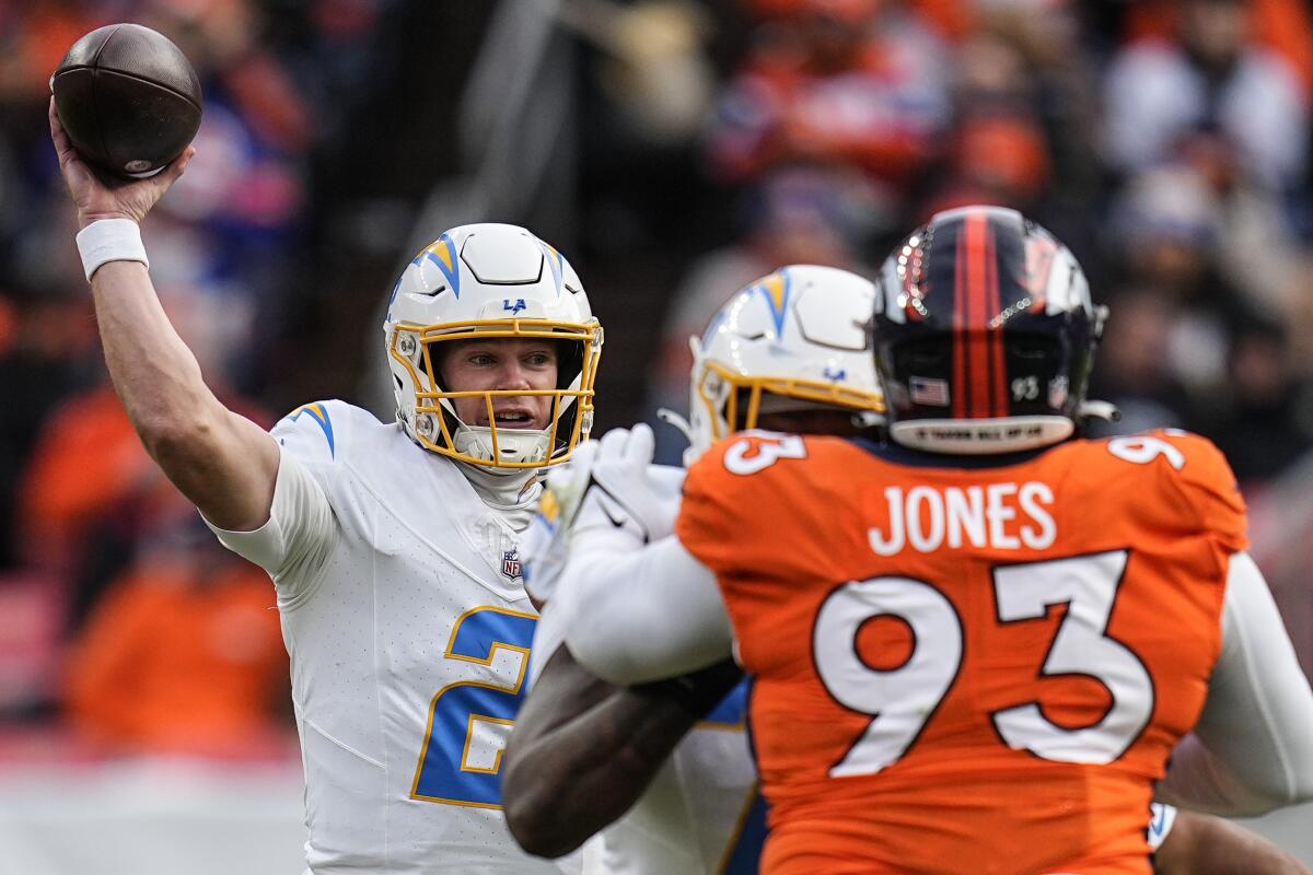 Chargers quarterback Easton Stick (2) throws under pressure from the Broncos' defense.