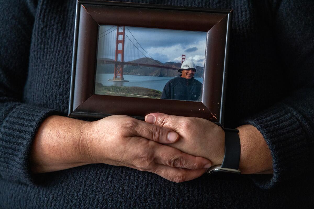 Sandra Muñoz holds a photo of her husband Luis on January 3, 2024.