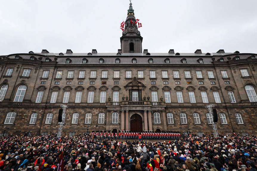 Crowds and guards in front of Christiansborg Palace.
