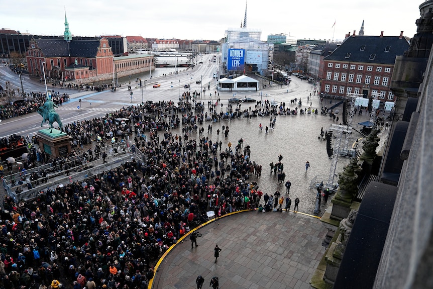 Large crowd of about 500 people gathered outside Christiansborg Palace.
