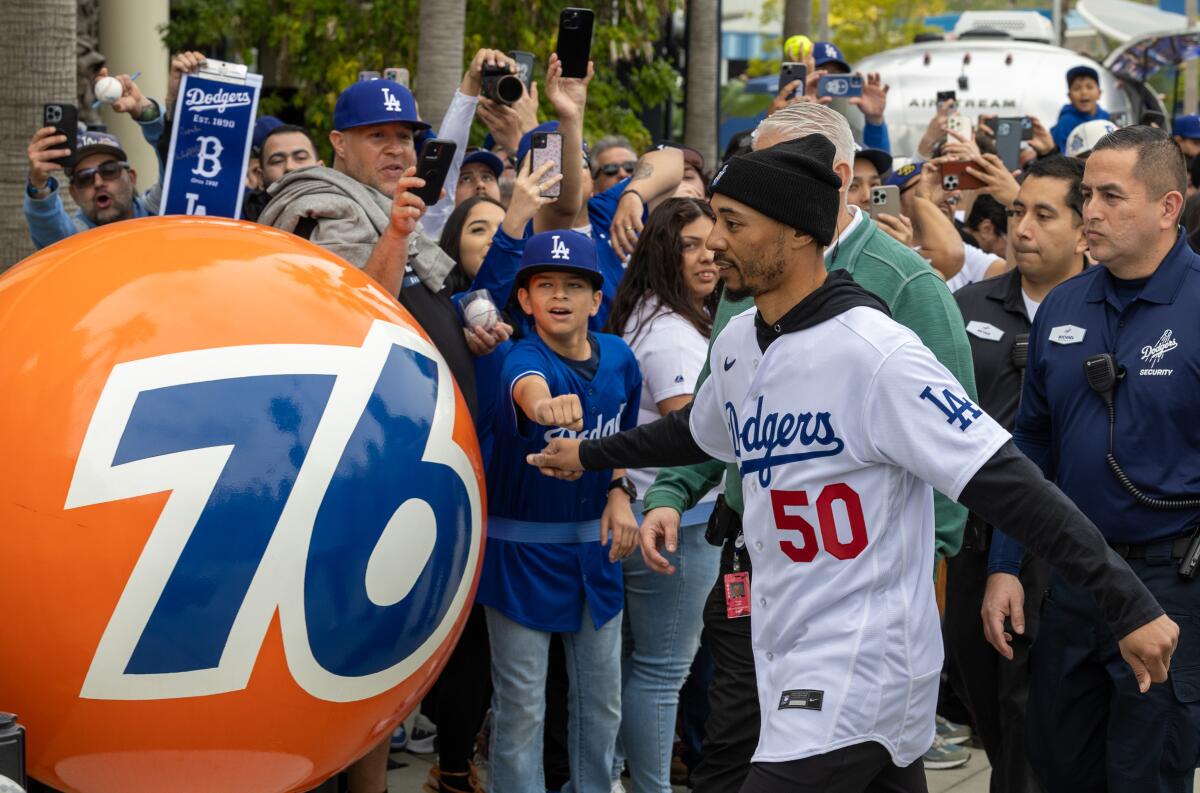 Dodgers star Mookie Betts fist bumps fan Andrew Ruiz, 12, at DodgerFest on Saturday.
