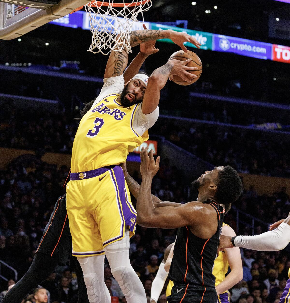 Lakers forward Anthony Davis gets an inside position on a defensive rebound against Shake Milton in the first half.
