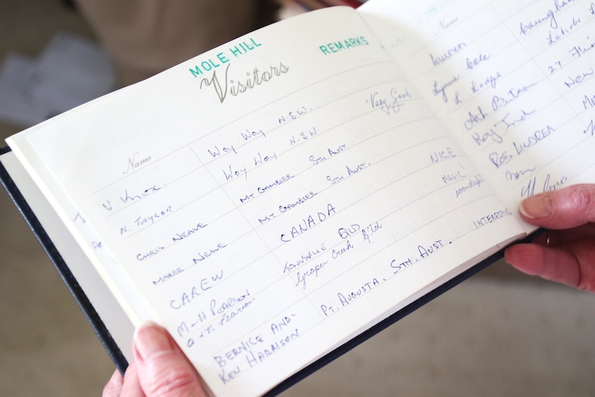 A faded guest book with the title "Mole Hill Visitors" with details of travelers from across the globe.