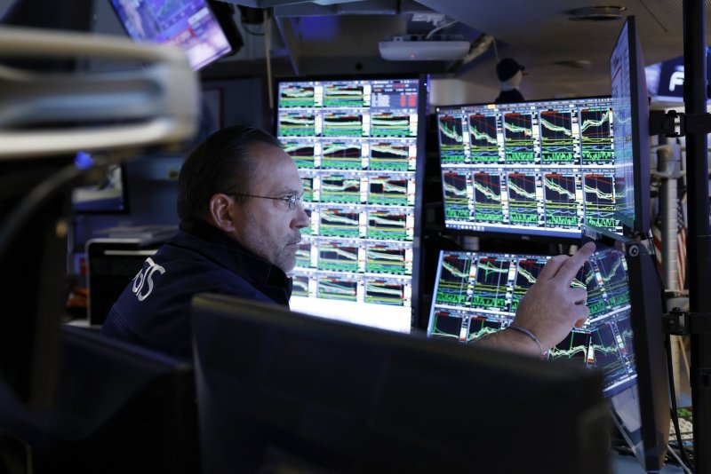 Traders work on the floor of the NYSE in April 2022. On Friday, the S&amp;P 500 closed above 5,000 for the first time ever. File Photo by John Angelillo/UPI