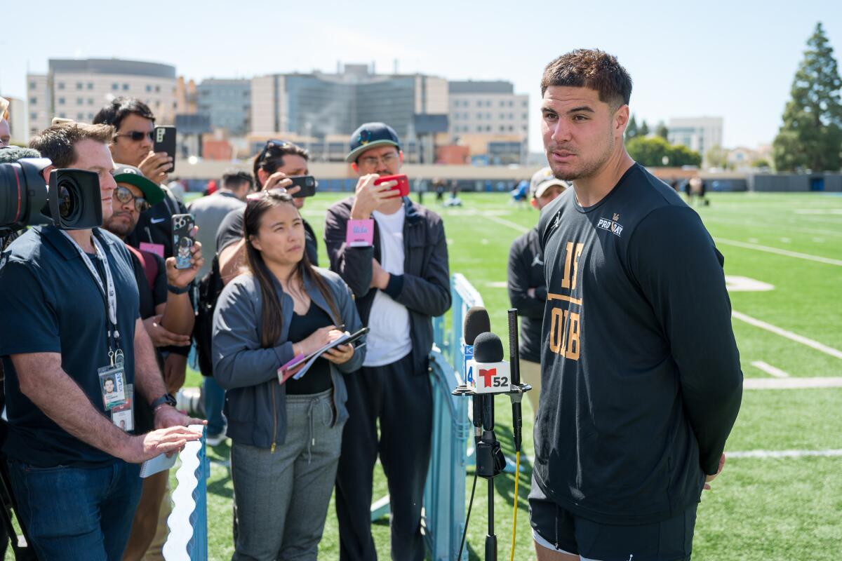 Laiatu Latu speaks with reporters after running drills at UCLA pro day on Friday.
