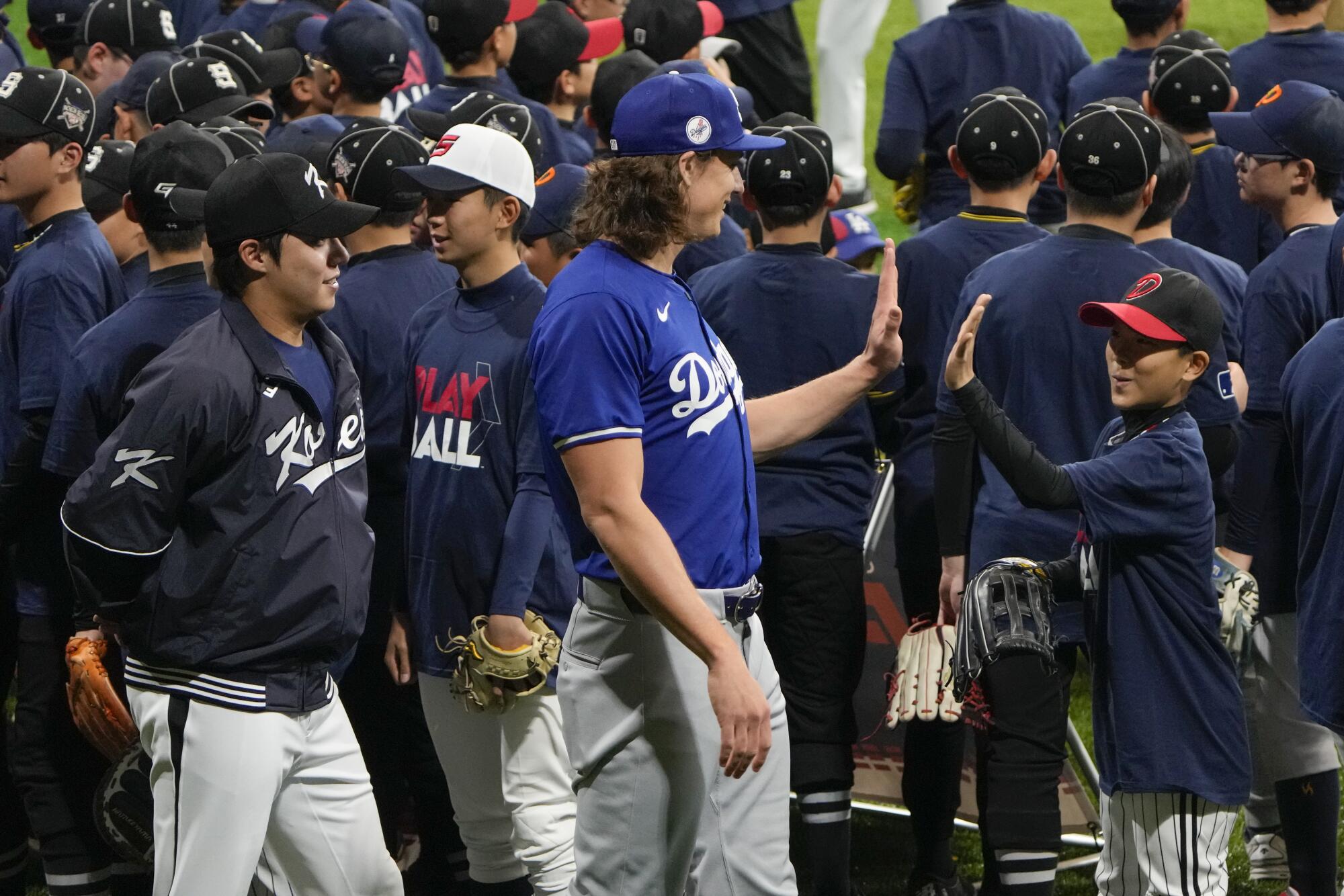 Tyler Glasnow, center, is greeted by a young fan during a skills clinic at Gocheok Sky Dome in Seoul, on March 16.