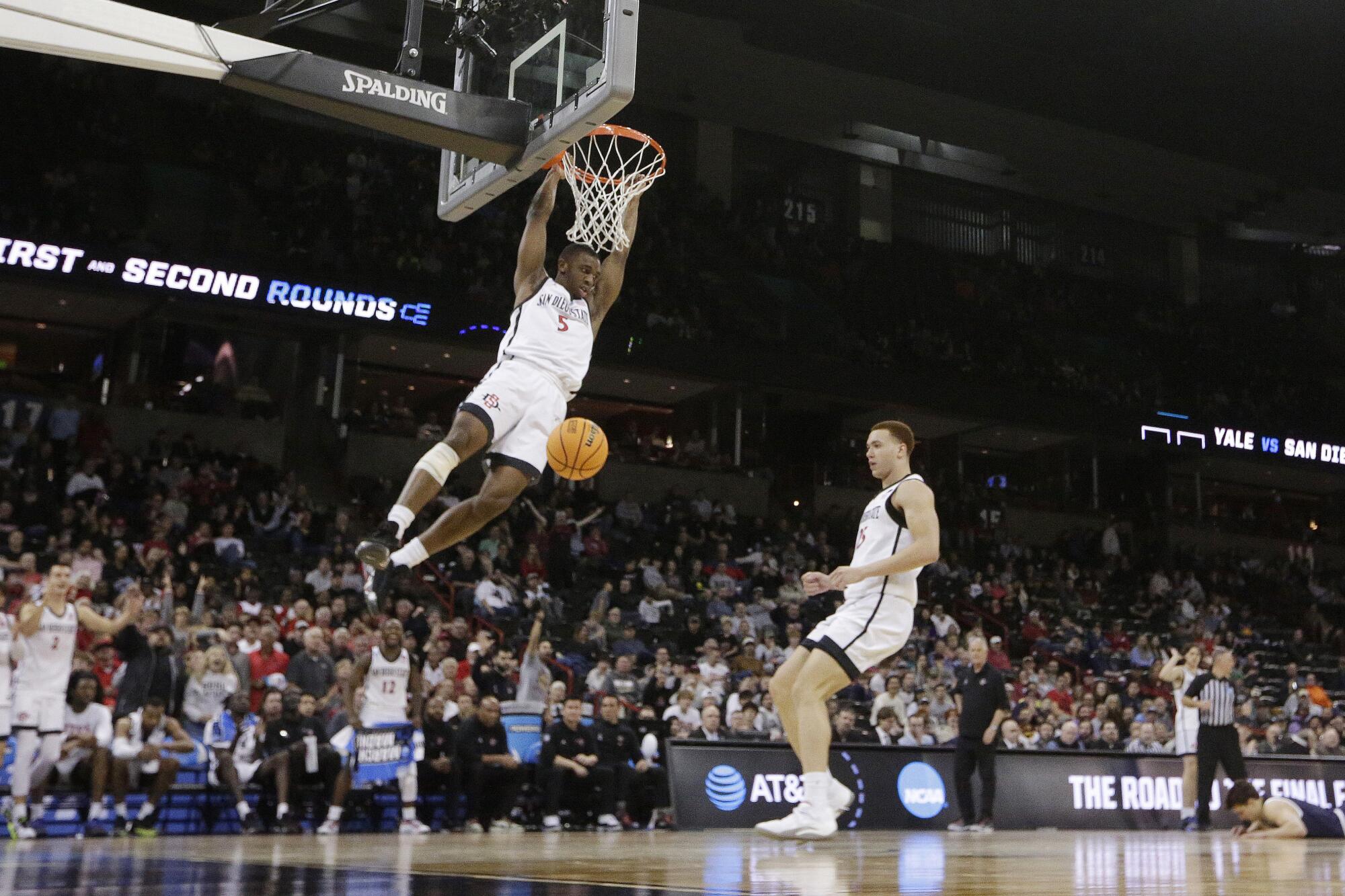 San Diego State guard Lamont Butler dunks during an NCAA tournament game.