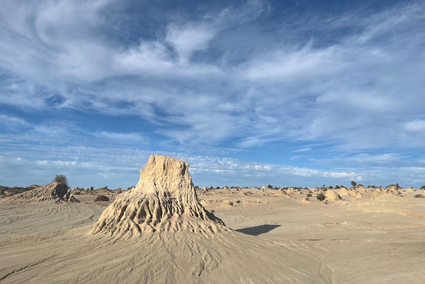 Sun casting shadows on mounds of eroded sand at dried Lake Mungo