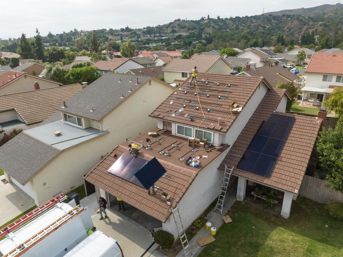 Rooftop solar panels are installed on a house in Brea in June.