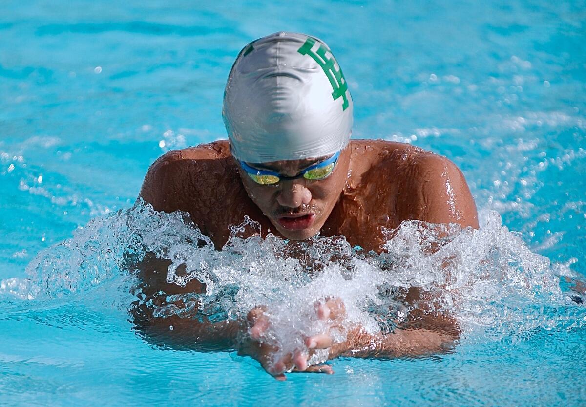 Eagle Rock junior Kenneth Devis clocks 57.04 seconds to set a City record in the 100-yard breaststroke.