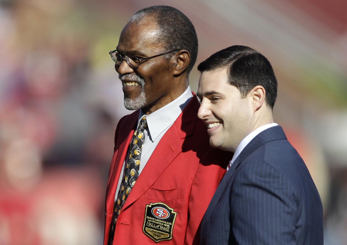 Jimmy Johnson, left, is honored by 49ers owner Jed York before a game.
