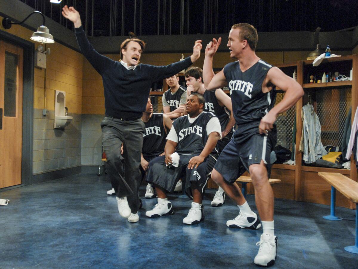 Peyton Manning, right, performs in a sketch with Will Forte, left, during an appearance on "Saturday Night Live."