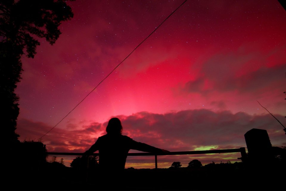 The Northern Lights shine colourfully and brightly over Doddiscombsleigh, Devon