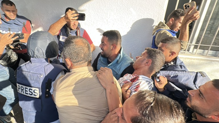 GAZA CITY, GAZA - OCTOBER 09: Al Jazeera cameraman Fadi al-Wahidi carried to Al Ahly Hospital for treatment after
