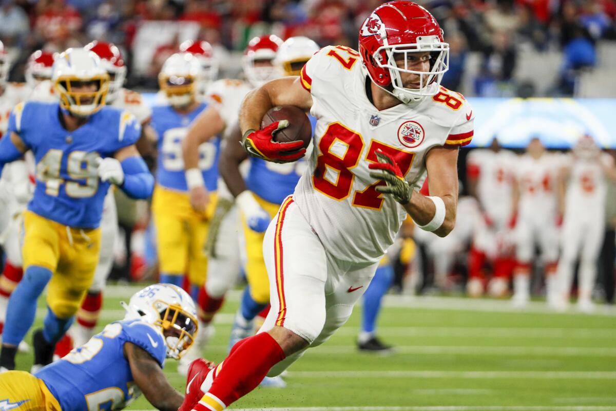 Kansas City Chiefs tight end Travis Kelce runs with the ball during a game against the Chargers at SoFi Stadium in 2022.