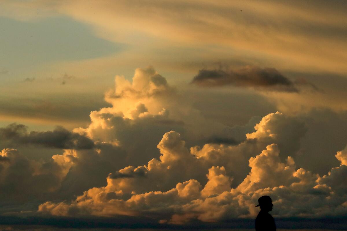 Tall piles of gold-colored storm clouds