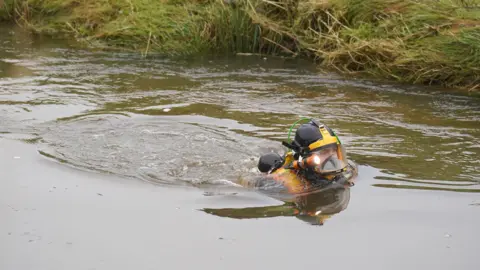 PA Media A diver searching in the river.