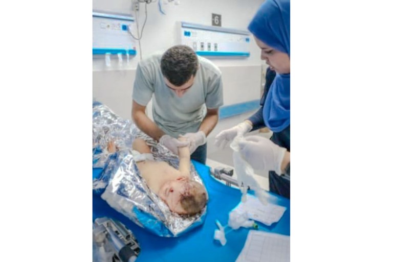 a photo of a nucrse and a doctor helping an injured toddler