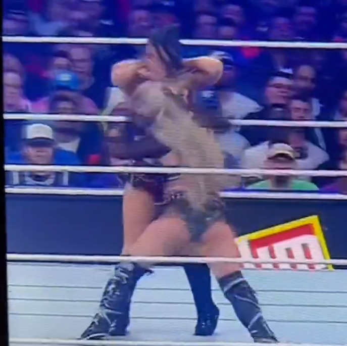 Screenshot of two female wrestlers grappling in a ring.