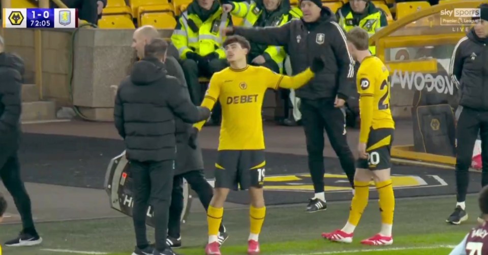 Soccer player being consoled by coaches.