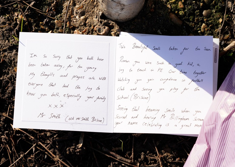Handwritten tribute left at a site where two people were killed in a hit and run.