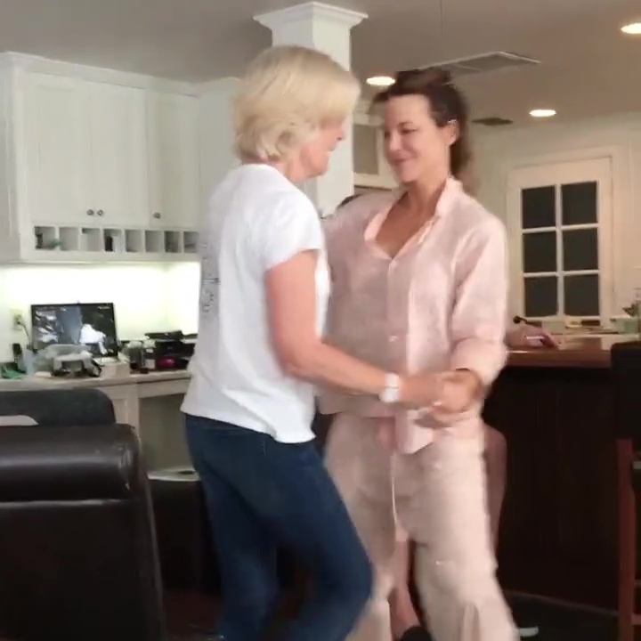 Kate Beckinsale and her mother dancing in a kitchen.
