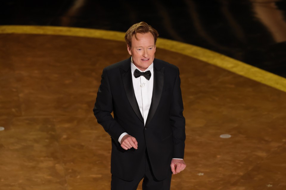 Conan O'Brien speaking onstage at the Oscars.