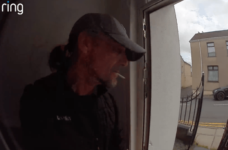 Man smoking at doorway.