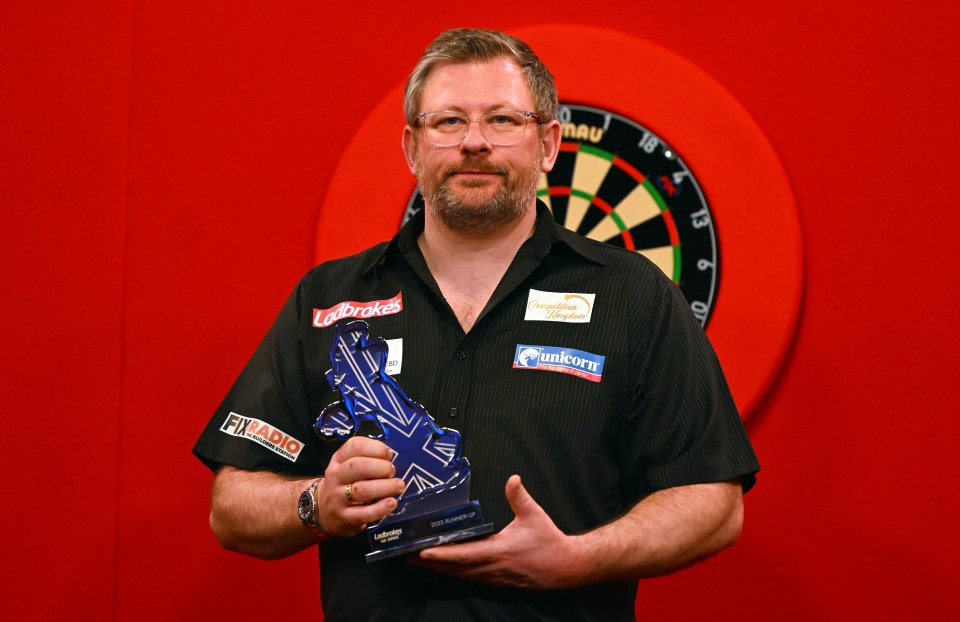 James Wade holding his runner-up trophy at the 2025 Ladbrokes UK Open.