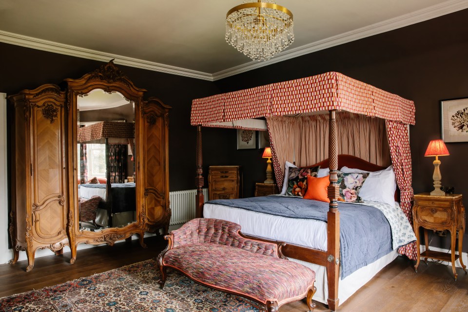 Renovated bedroom with four-poster bed and antique furniture.