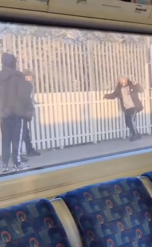 Footage of a fight between several hooded figures at a tube station.