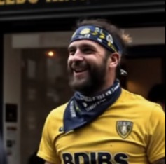 A Leeds United fan smiling.