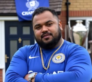 Man in Leicester City jersey.