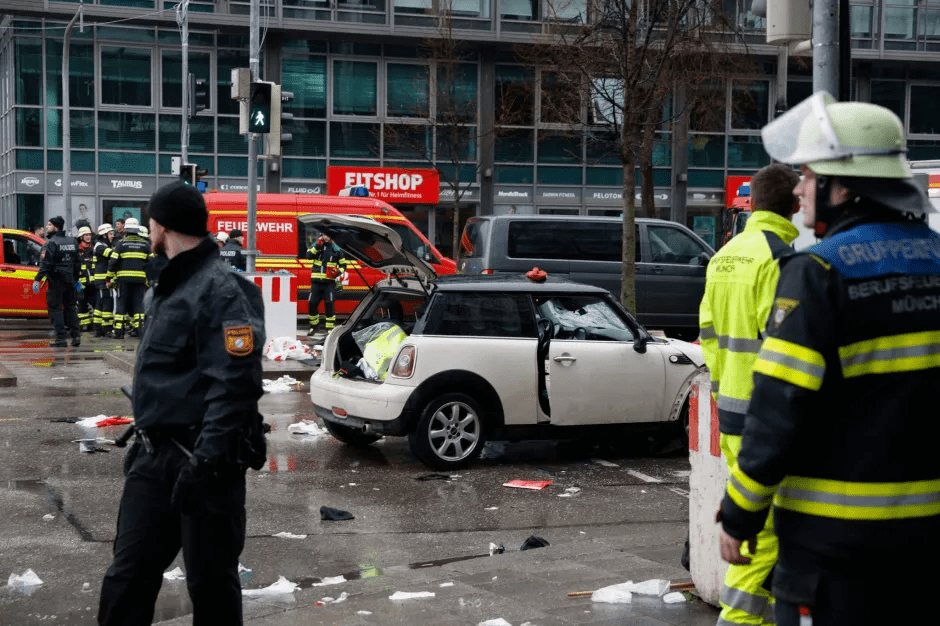 Aftermath of a car accident with emergency responders and debris on the street.