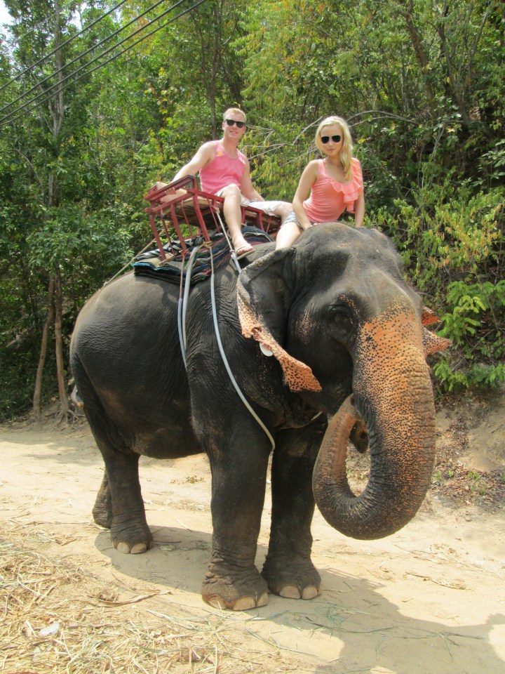 Couple riding an elephant.