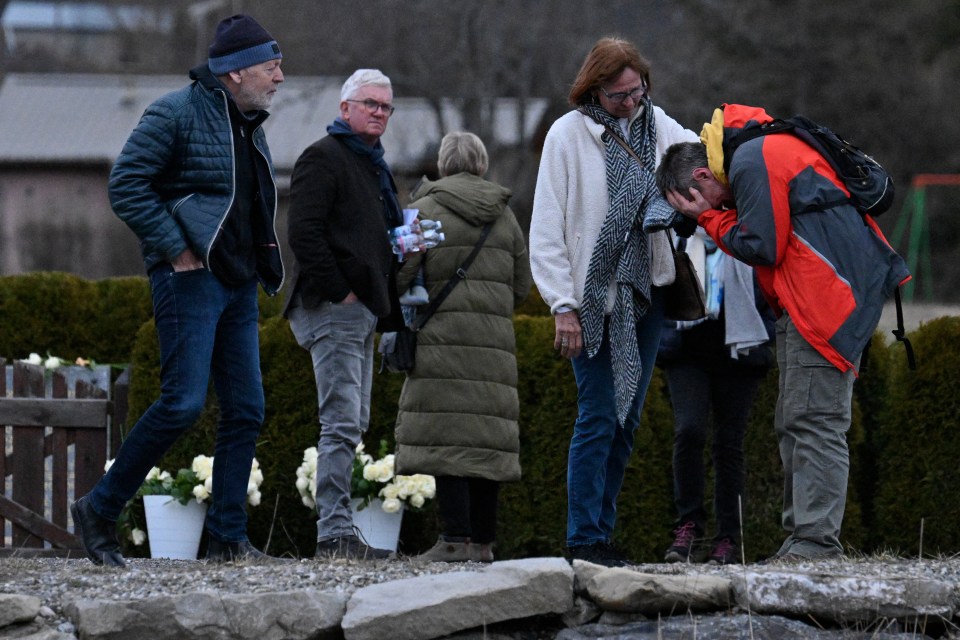 Mourners at a memorial.