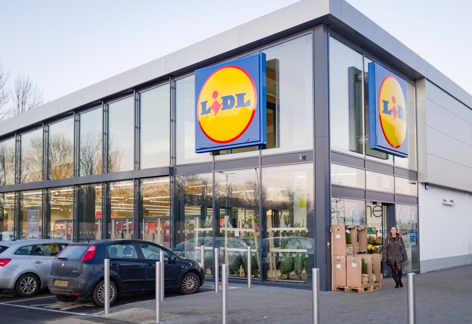 Exterior of a Lidl supermarket with a woman walking out.