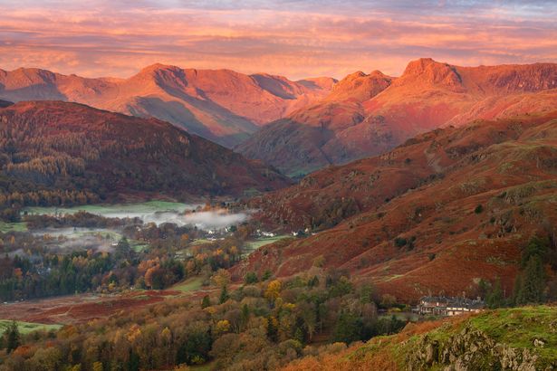 Breathtaking Winter sunrise light on the Langdale mountain range in the Lake District, UK. Taken from Loughrigg Fell on a beautiful Autumn morning.