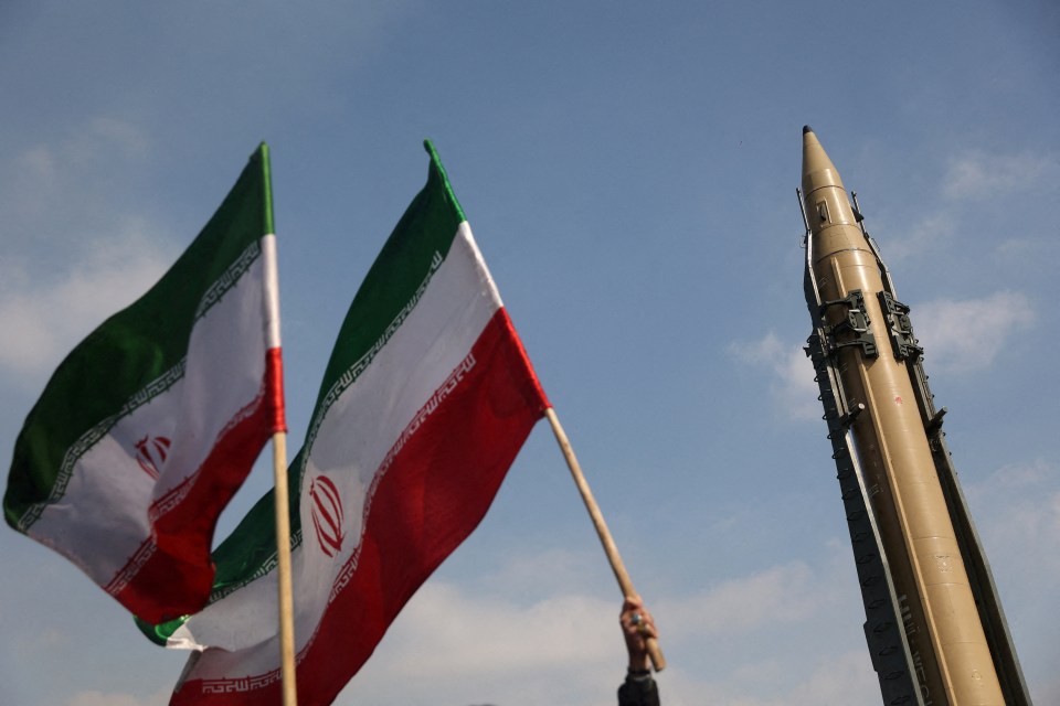 Iranian flags and a missile on display.