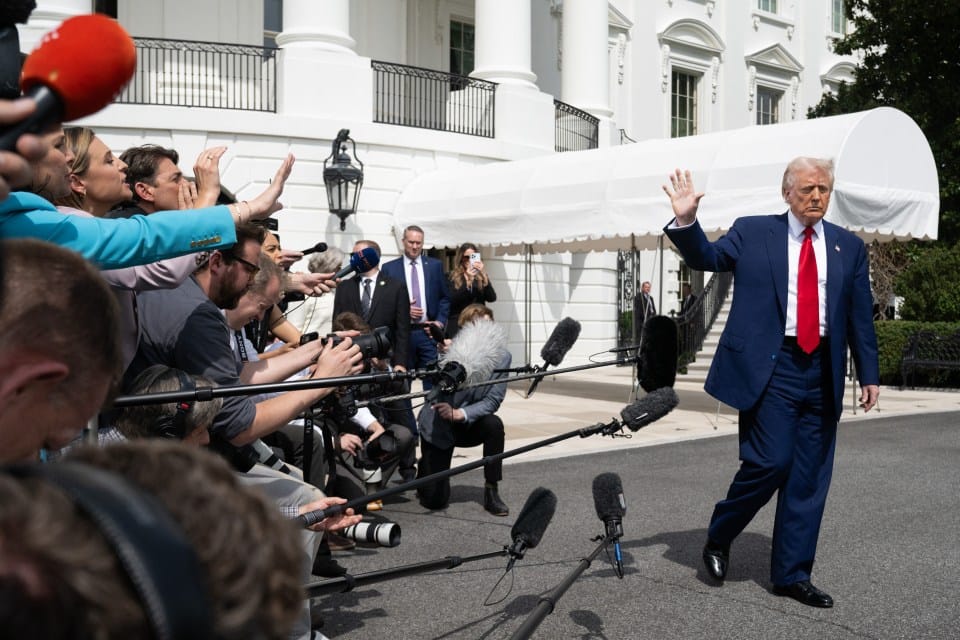 President Trump leaving the White House and waving to the press.