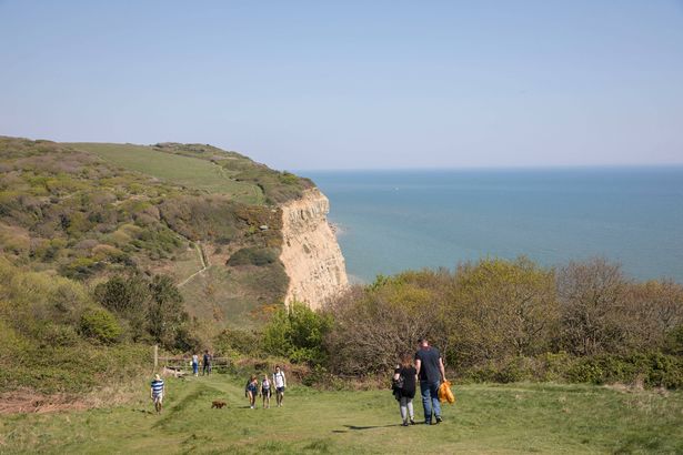 People walking along East Hill cliffs in the Hastings Country Park Nature Reserve