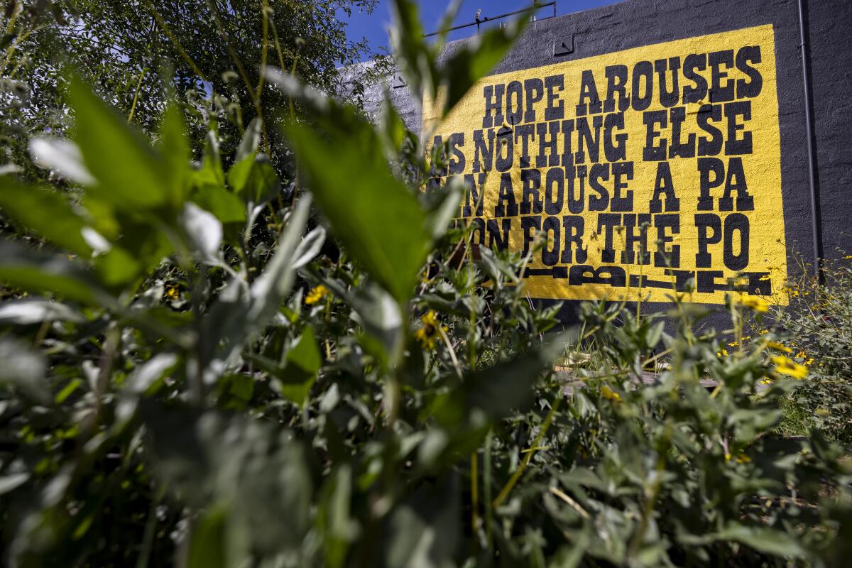 A reproduction of a Corita Kent mural that reads, "Hope Arouses as Nothing Else Can Arouse a Passion for the Possible" 