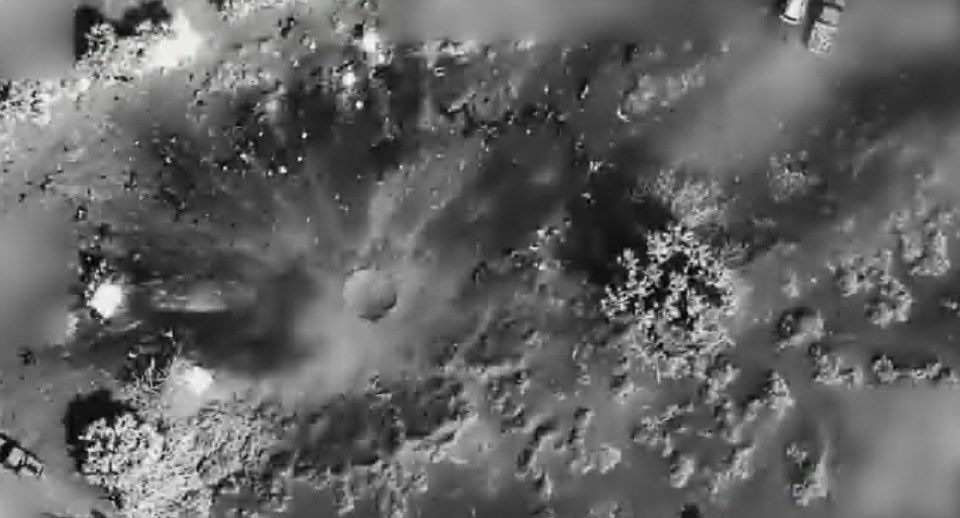 Black and white aerial image of a drone strike.