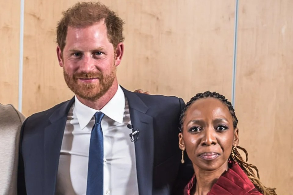 Group photo of Prince Harry with four other individuals at a panel discussion.