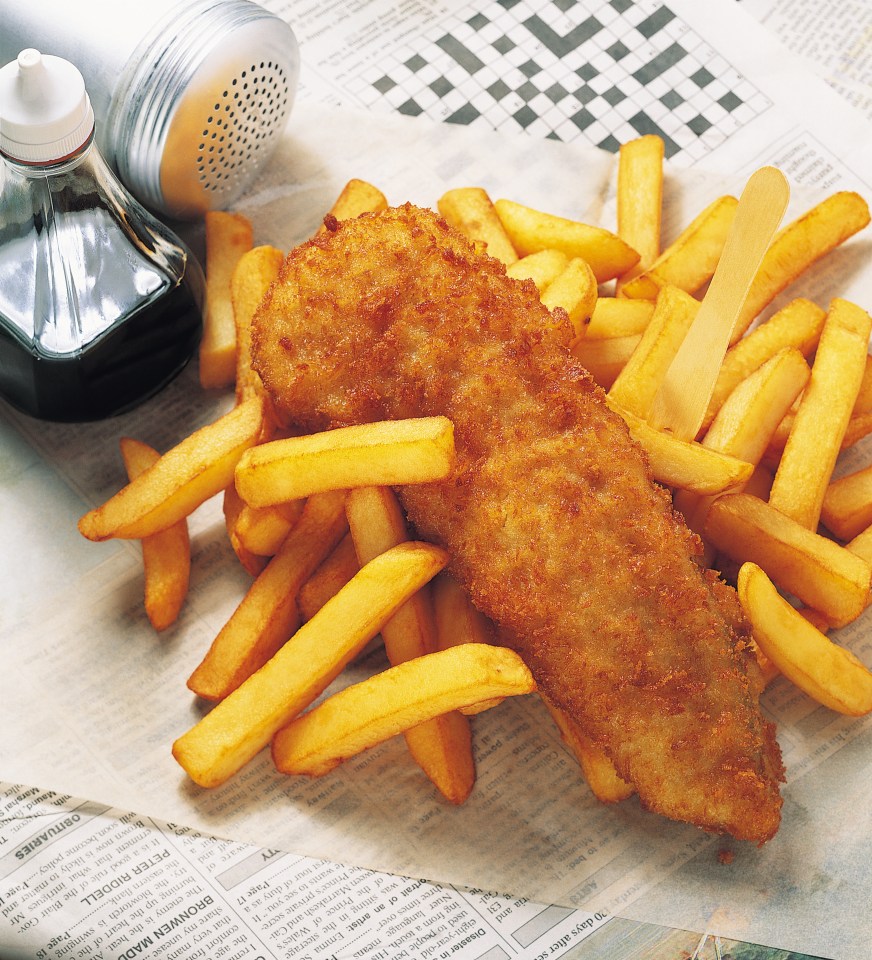 Fish and chips with french fries on newspaper.