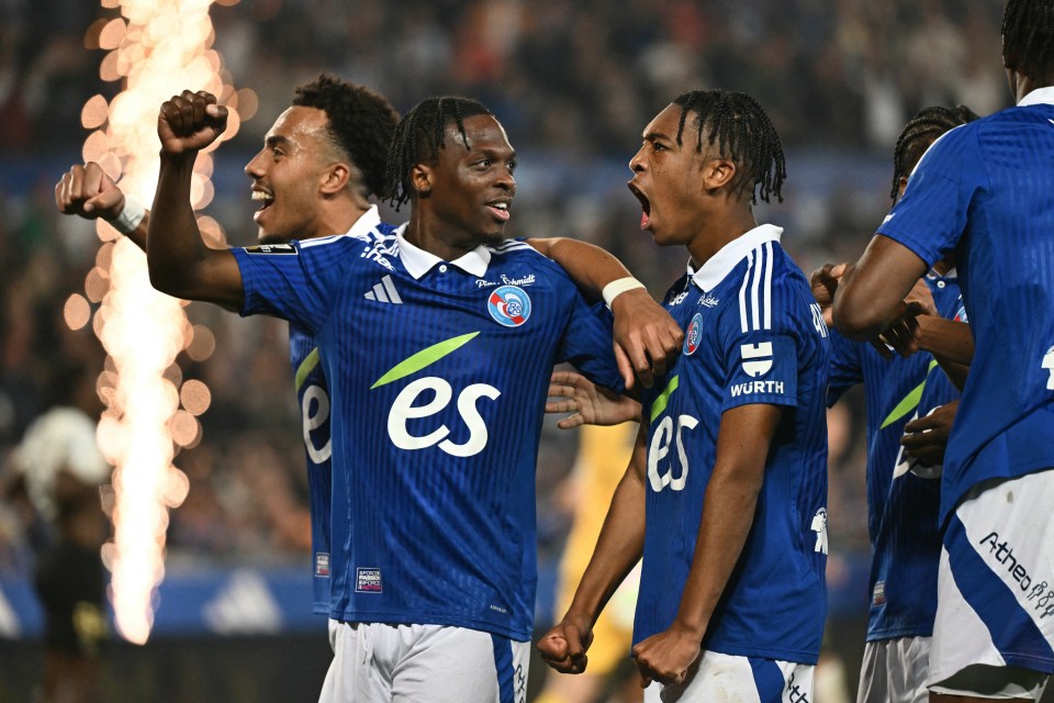 Soccer players celebrating a goal.